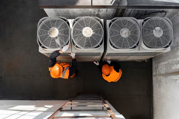 Crew installing a bank of commercial condenser units
